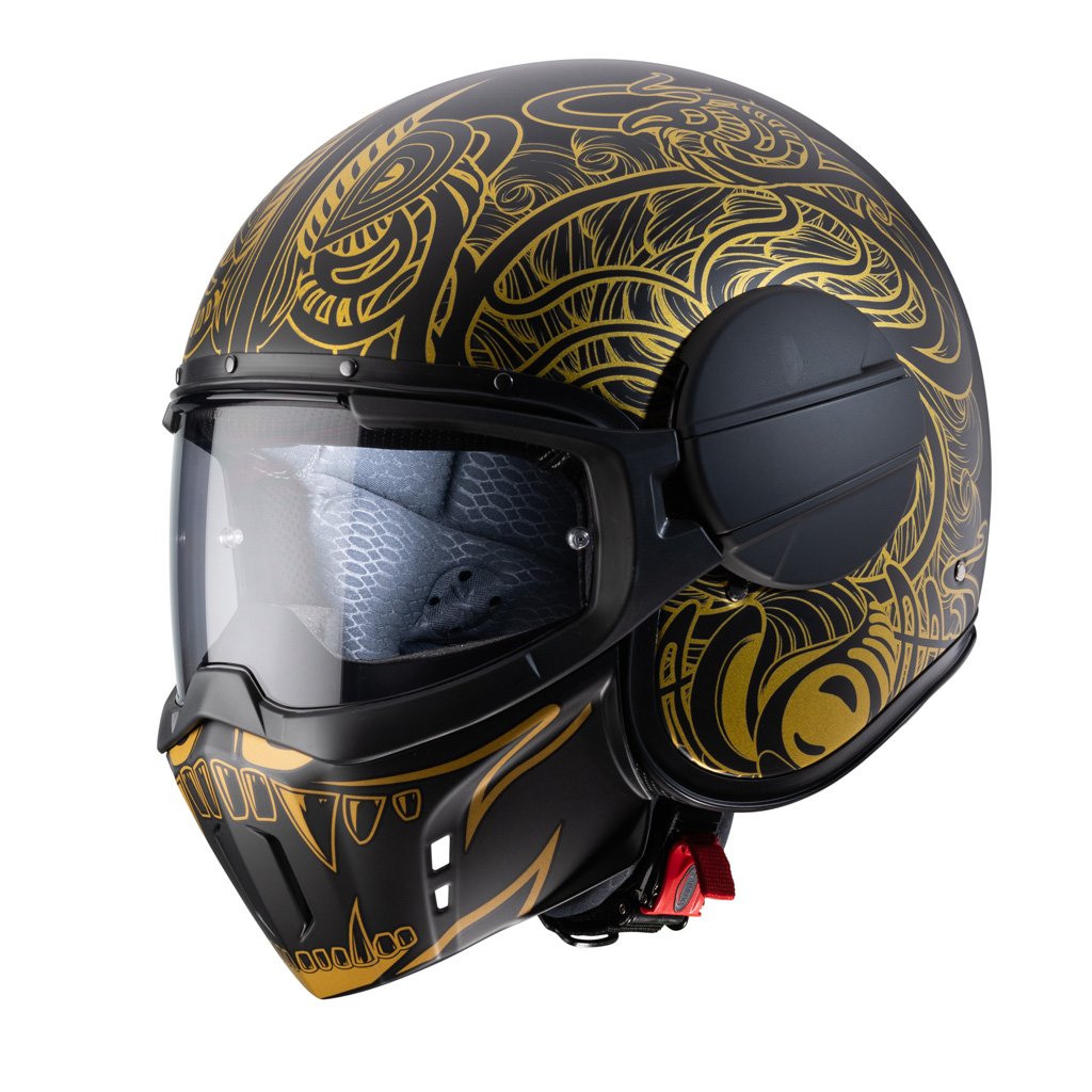 Caberg Ghost Maori Jet Helmet in matte black and gold, three-quarter view, aggressive design with Maori graphics.